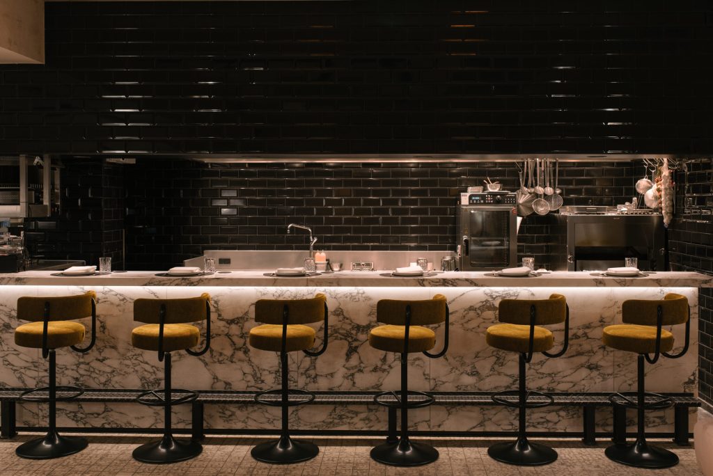 Dine at the beautiful bar, which provides you with live cooking through the open kitchen.