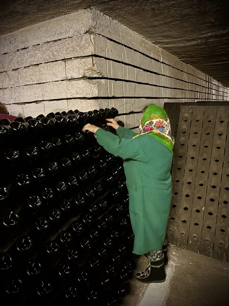Turning of the bottles is still done by hand as pictured here.