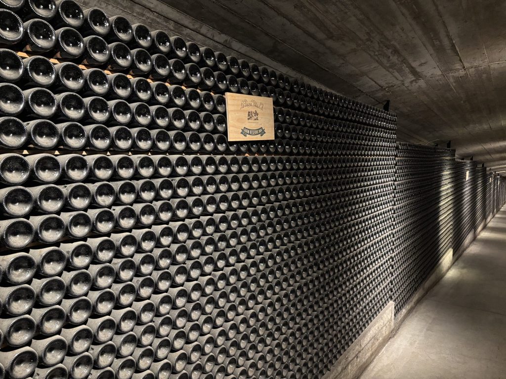 Massive underground storage at La Rioja Alta S.A. with bottled wines ageing.